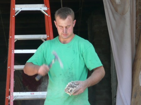 Artur, (a different Artur), knocking mortar off of bricks
